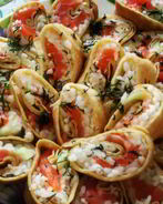 Роллы из блинов со сливочным сыром, семгой и авокадо